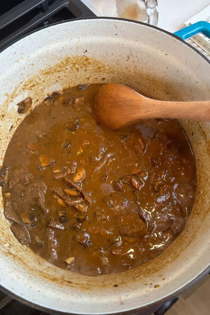 Delicious Beef Stroganoff in enameled cast iron pot with rich brown sauce.