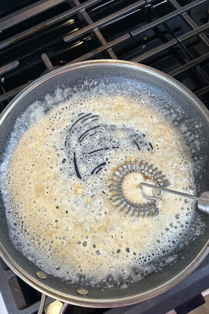 Pan with whisk stirring melted butter and flour together.