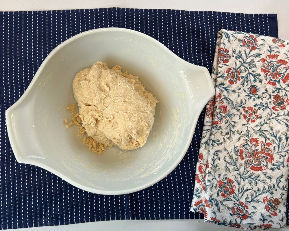 Homemade Challah dough in a rough mix sitting in mixing bowl