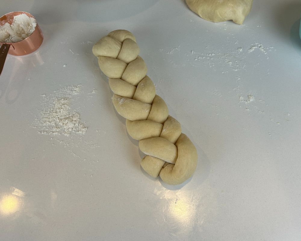 Complete Homemade Challah braid on white counter top.