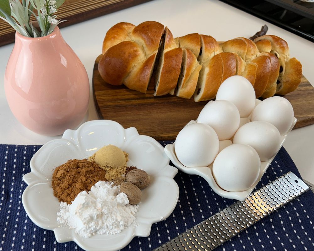 Challah French toast ingredients including spices, eggs, and sliced Challah.