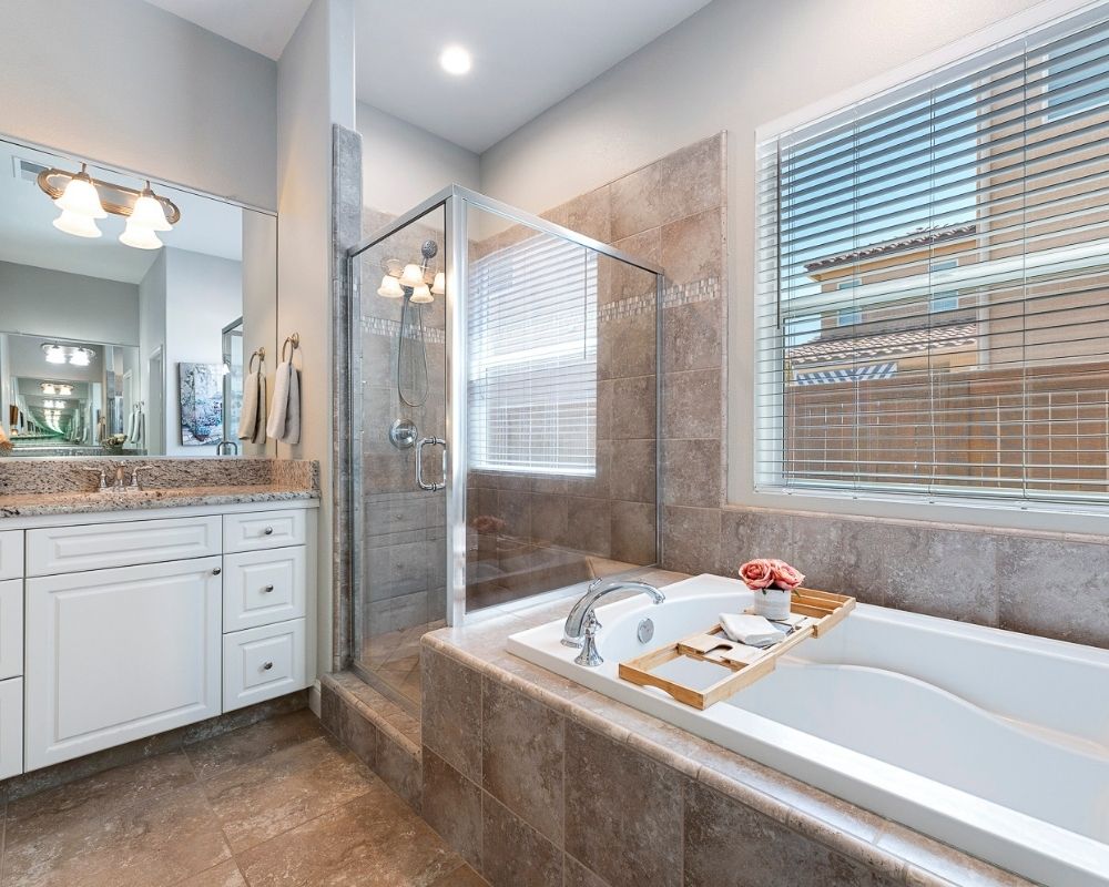 Master bath with tub, tile shower and sink vanity.