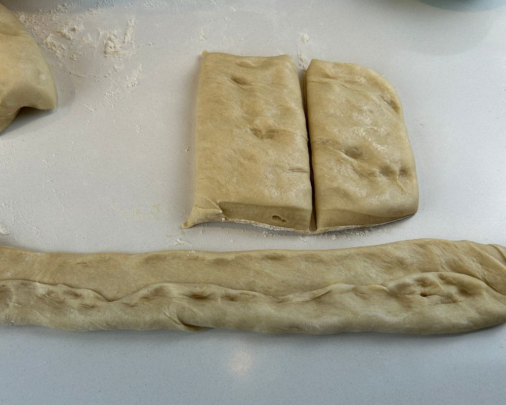 Challah dough flattened and prepared for shaping into strands