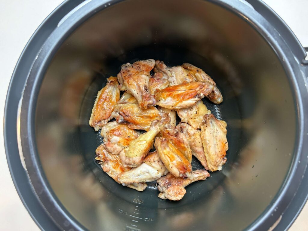 Roasted chicken pieces on a baking sheet for homemade stock